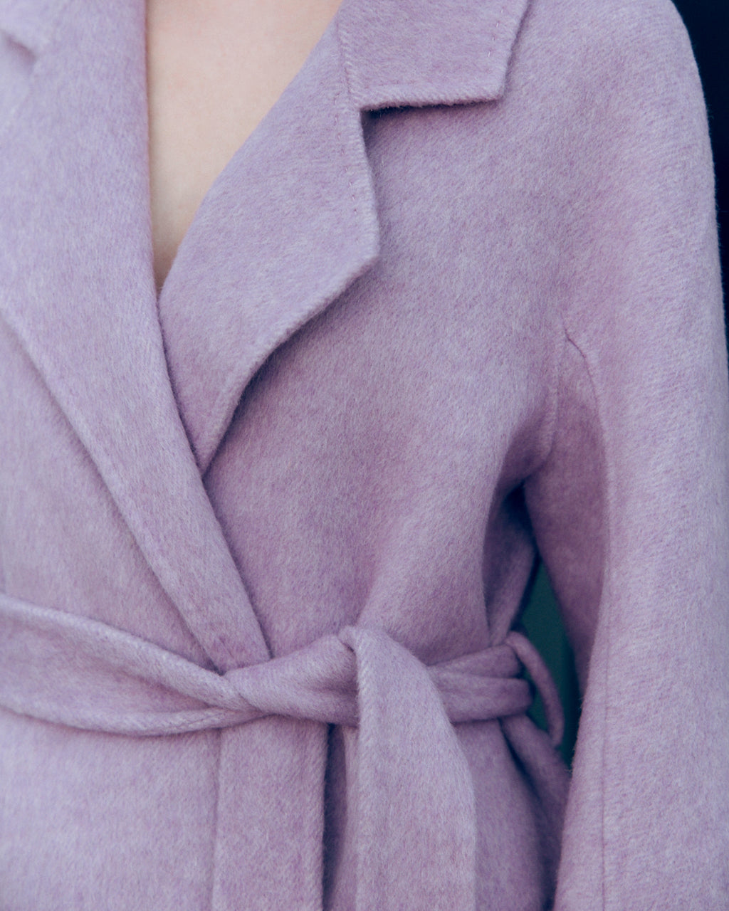 Lavender wool-cashmere robe coat with wide lapels, self-tie belt, and oversized silhouette. Soft brushed texture and elegant drape for modern layering