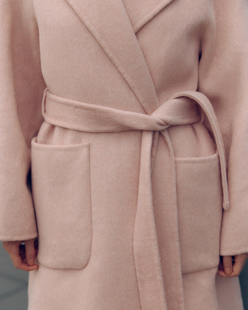 Soft pink oversized wool-blend coat for women featuring wide lapels, drop shoulders, and large patch pockets. Designed with minimalist Japanese tailoring for a relaxed yet elegant silhouette. Perfect for fall and winter layering, this robe-style coat embodies timeless slow fashion and effortless sophistication — crafted for comfort, warmth, and modern everyday wear.