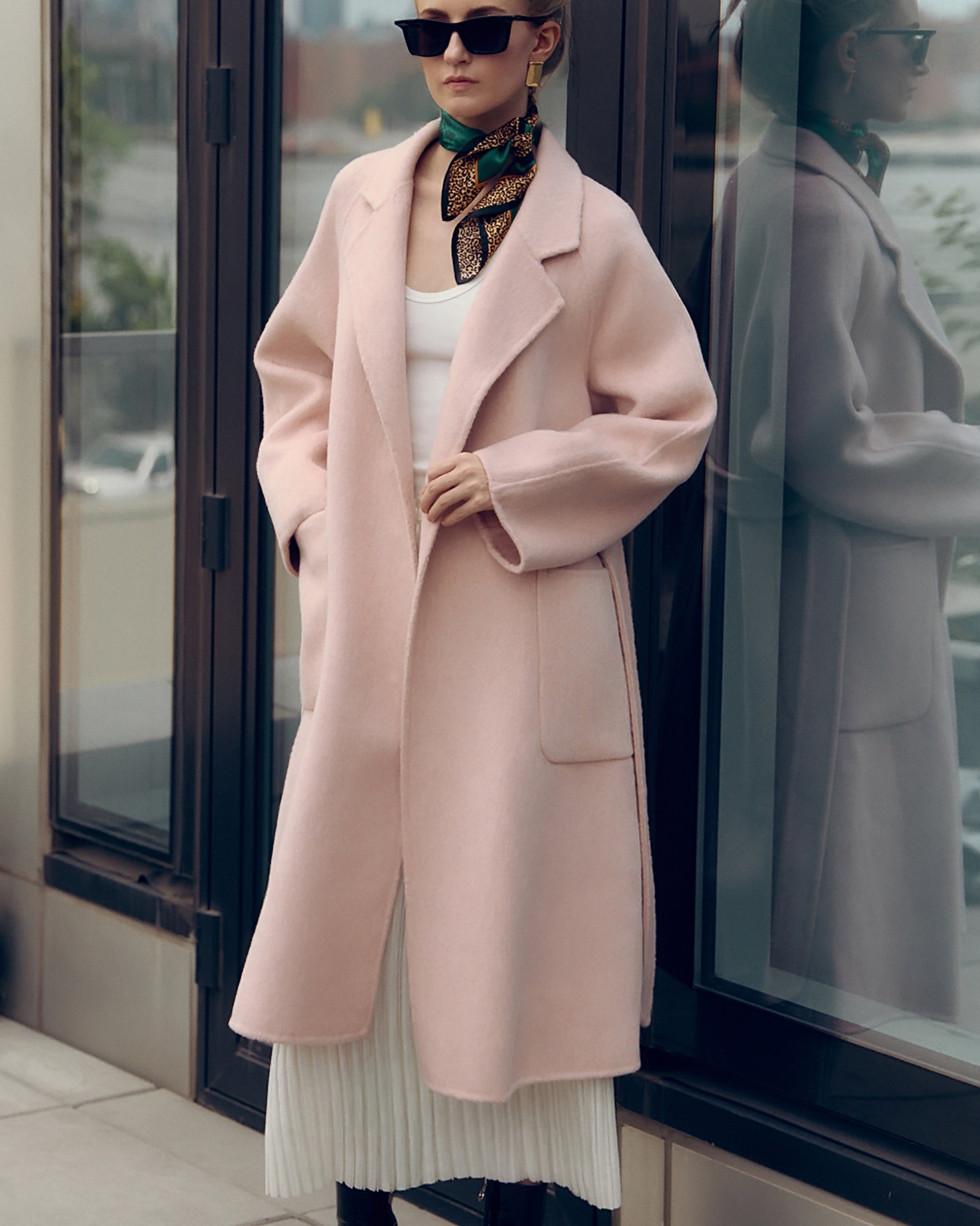 Soft pink oversized wool-blend coat for women featuring wide lapels, drop shoulders, and large patch pockets. Designed with minimalist Japanese tailoring for a relaxed yet elegant silhouette. Perfect for fall and winter layering, this robe-style coat embodies timeless slow fashion and effortless sophistication — crafted for comfort, warmth, and modern everyday wear.
