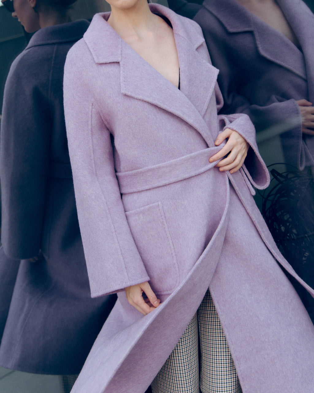 Lavender wool-cashmere robe coat with wide lapels, self-tie belt, and oversized silhouette. Soft brushed texture and elegant drape for modern layering