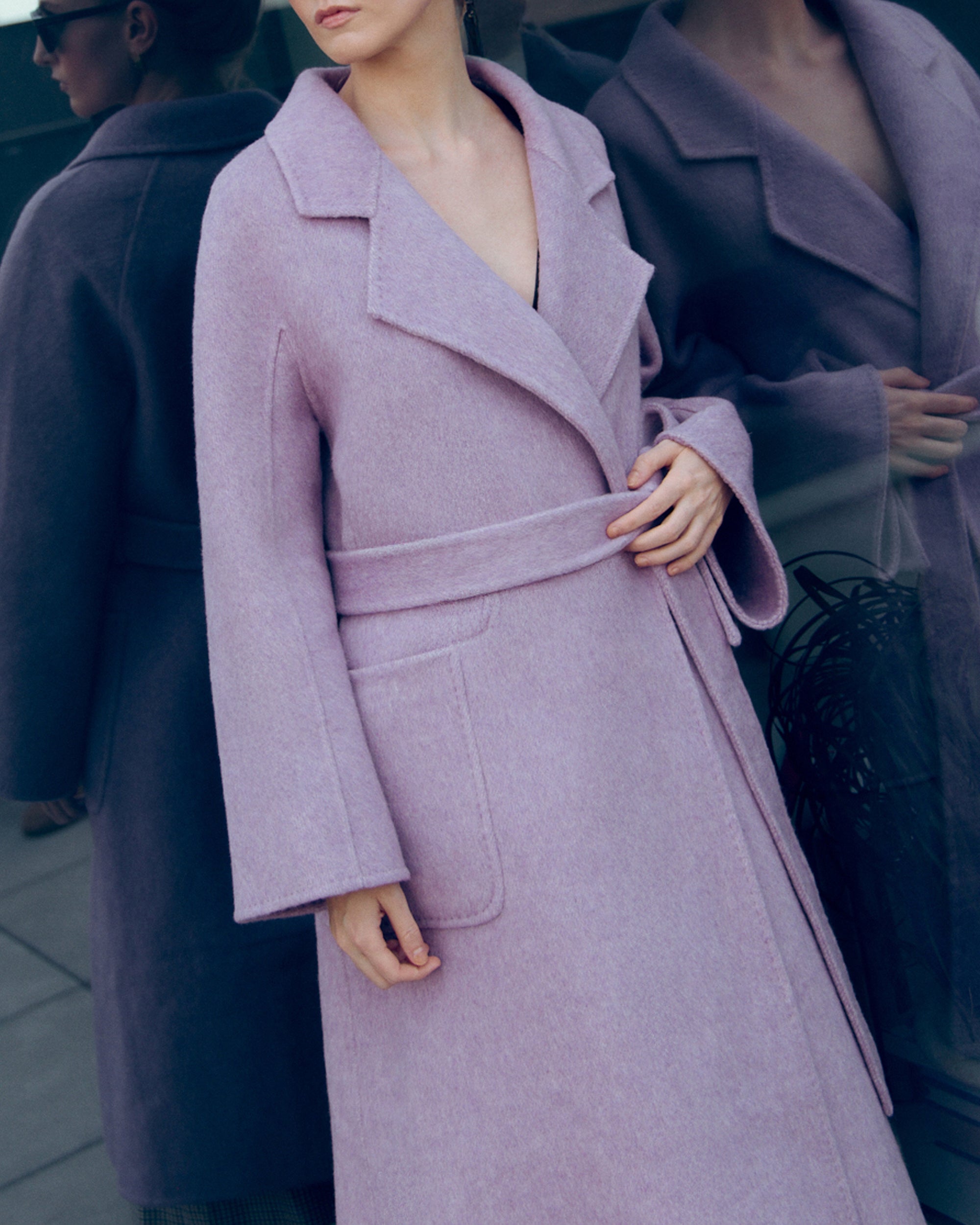 Lavender wool-cashmere robe coat with wide lapels, self-tie belt, and oversized silhouette. Soft brushed texture and elegant drape for modern layering.