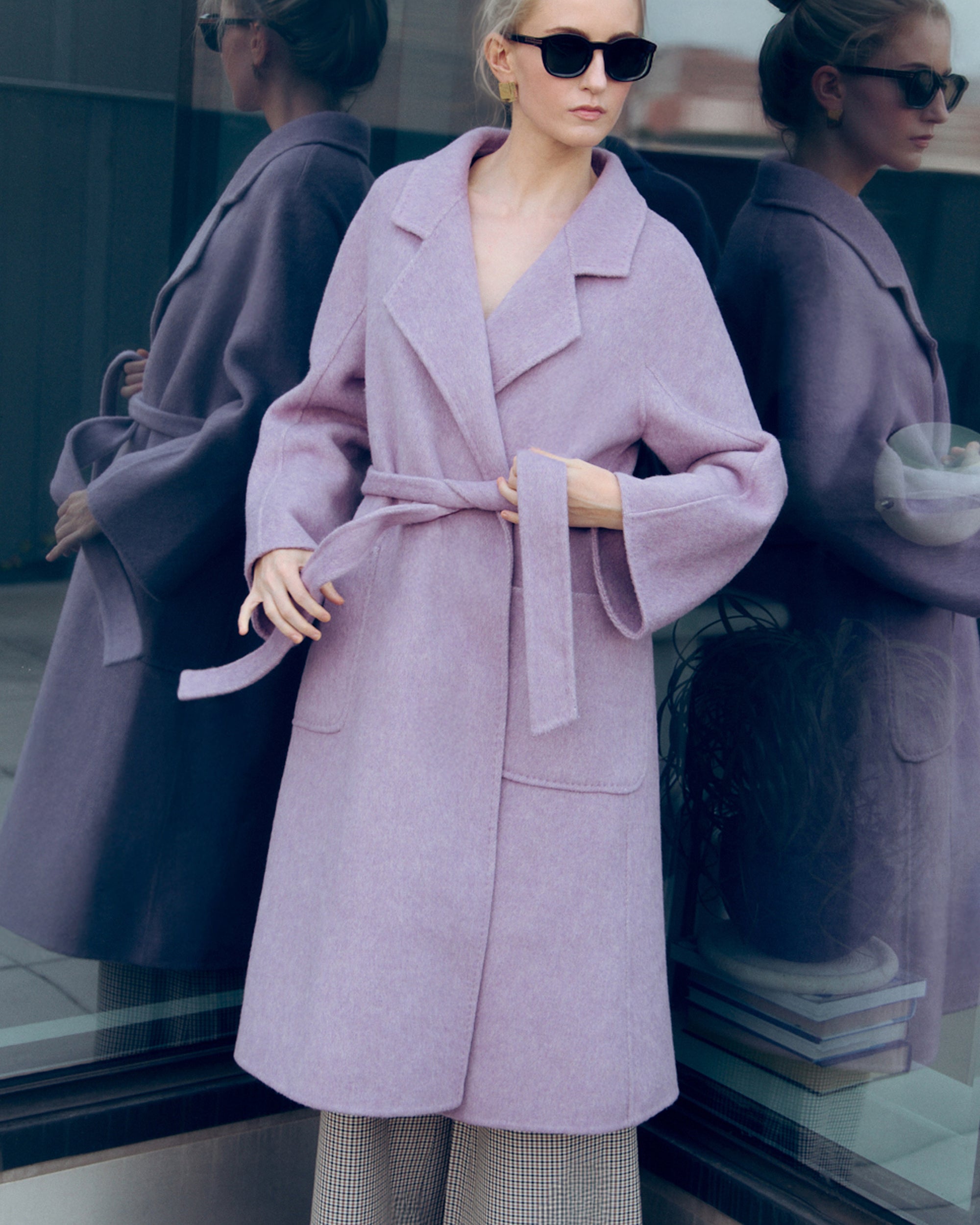 Lavender wool-cashmere robe coat with wide lapels, self-tie belt, and oversized silhouette. Soft brushed texture and elegant drape for modern layering
