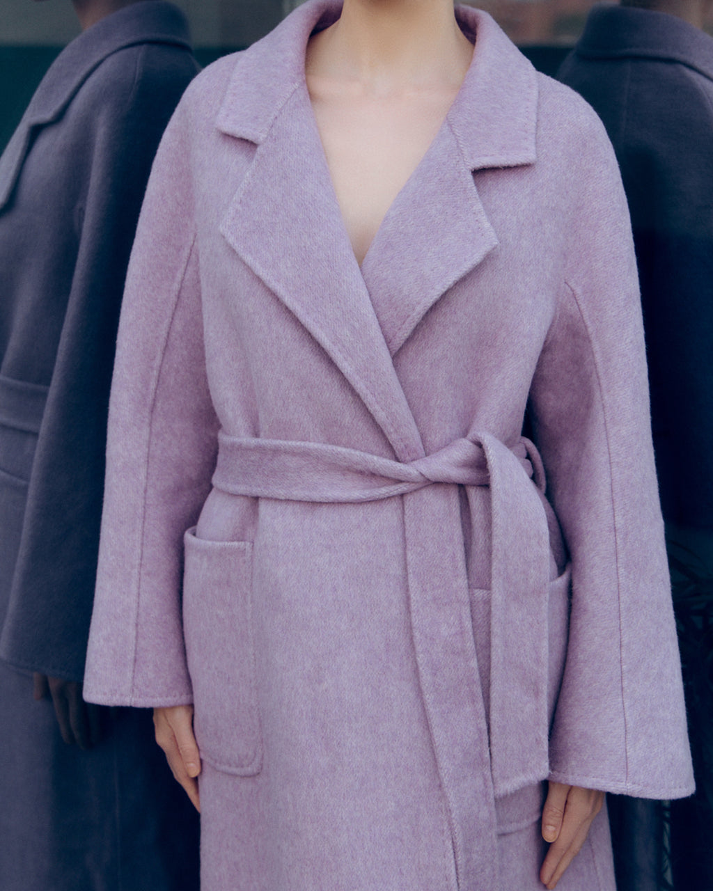 Lavender wool-cashmere robe coat with wide lapels, self-tie belt, and oversized silhouette. Soft brushed texture and elegant drape for modern layering